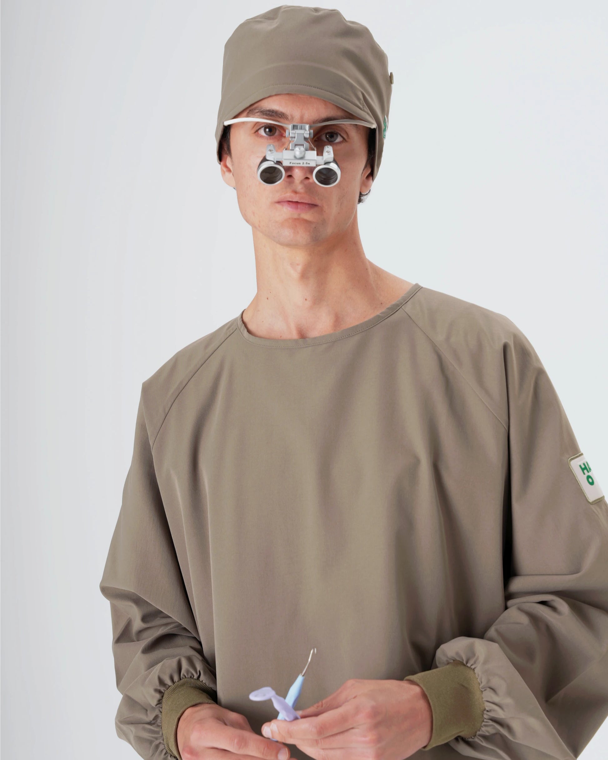 HANDS ON sürdürülebilir haki modern medikal scrub lifestyle erkek manken yakın görünüm.